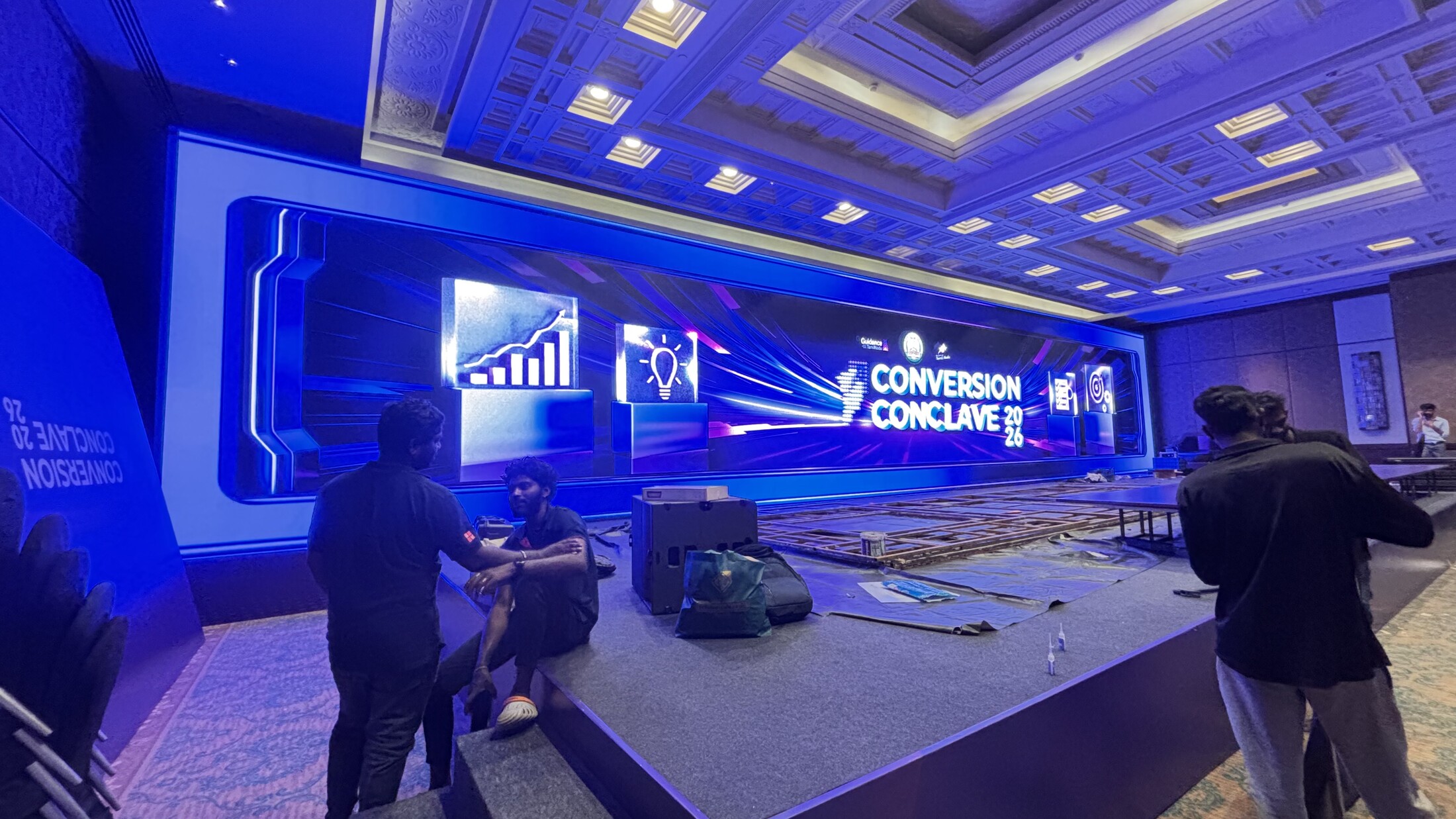 AVX crew rigging a large-format LED wall on site ahead of a conference